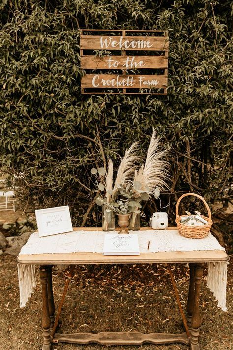 This rustic + boho welcome table features pampas grass and greenery floral pieces | Image by Maya Lora Photo Boho Wedding Signing Table, Boho Guestbook Table, Ceremony Entrance Table, Rustic Wedding Entry Table, Boho Card Table Wedding, Boho Wedding Guest Book Table, Boho Guest Table Wedding, Boho Guest Book Table, Boho Memory Table Wedding