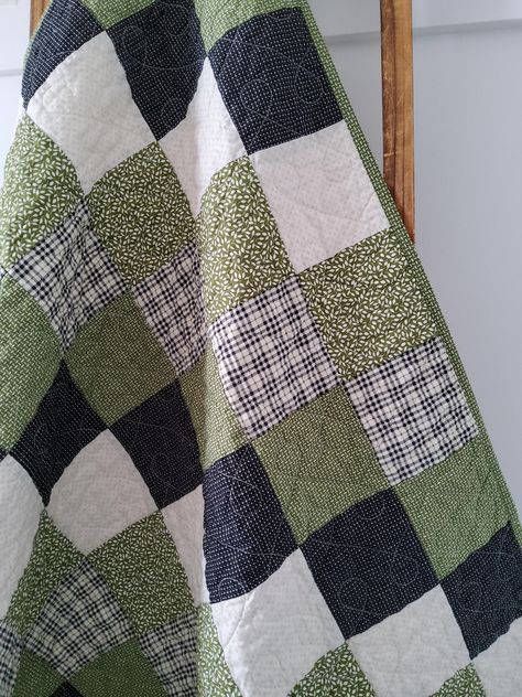 - Green & Black Baby Boy Quilt for Sale  - Handmade Patchwork Quilt  - 100% Cotton Fabrics - Dimensions 36" x 46" - Machine quilted loopy design - Durable Double-Fold Binding -Easy Care: Machine wash and dry on gentle This quilt is made from three layers of soft cotton fabrics. The front is a patchwork of green, black and plaid prints. The backing is a soft cotton fabric that is white with subtle tan details. The middle layer is soft cotton/bamboo  batting. It is finished with double fold bindin Green And Black Quilts, Quilts For Guys, Outdoorsy Quilt, Baby Shower Quilt Squares, Green Quilt Bedding, Quilt Green, Dark Green Quilt Ideas, Simple Square Quilt, Green And White Quilt