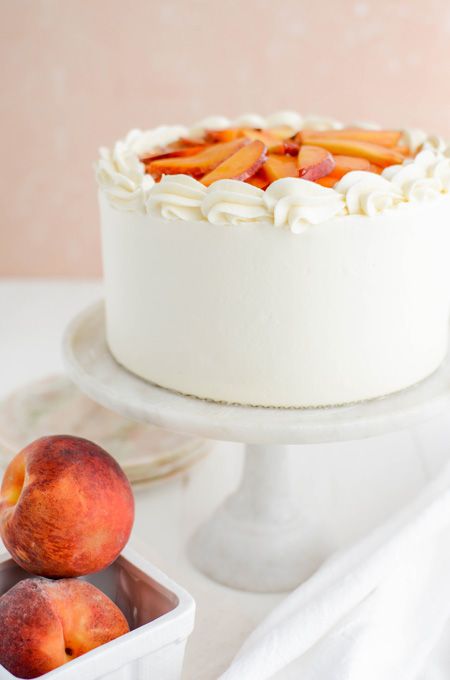 Peaches and Cream Layer Cake close up on cake pedestal. Peach Cobbler Layer Cake, Peach And Cream Cake, Summer Layer Cake, Peach Layer Cake, Peach Cake Filling, Summer Cake Flavors, Peach Cake Design, September Cake, Unique Cake Flavors