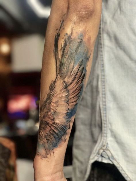 arm-tattoo-blue-watercolor-angel-and-demon-tattoo-blurred-background Tattoo Wings Arm, Angel Arm Tattoo, Forearm Wing Tattoo, Wing Neck Tattoo, Wings Tattoo Meaning, Beautiful Angel Tattoos, Tattoo Wings, Heart With Wings Tattoo, Wing Tattoos On Back