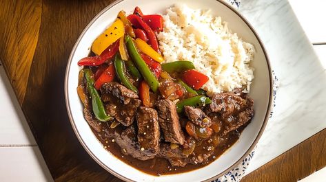 This Crockpot pepper steak recipe delivers tender beef strips and colorful bell peppers simmered in a savory, slightly sweet sauce. The slow cooker brings out incredible flavors, making it the perfect easy dinner for busy nights. Try this recipe today – see full instructions #crockpotrecipes #peppersteak #beefrecipes #easymeals #slowcooker #comfortfood #weeknightdinner #asianinspired #slowcooked Crockpot Steak Recipes, Crockpot Pepper Steak, Strip Steak Recipe, Crockpot Stuffed Peppers, Crockpot Steak, Pepper Steak Recipe, Slow Cooker Stuffed Peppers, Beef Strips, Bell Pepper Recipes