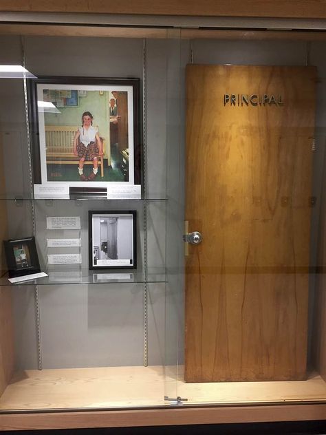 Image: A display case with photos, an illustration and the door that was once on the Principal's office at Cambridge Central Schools in Cambridge New York School, Principals Office, School Principal, Black Door, Book Corners, Black Doors, Reading Challenge, Norman Rockwell, Science Teacher