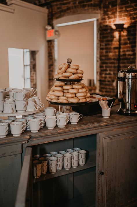 Are you as obsessed as we are about this donut and coffee bar at this rustic styled wedding? Designed by @ramblewoodevents, this two-tier donut and cupcake stand with vintage styled mugs made our heart flutter. This was a total hit with all the guests!  Are you looking for help with floral design, catering, coordinating, or planning your wedding or event? Contact Ramblewood Event and Design today! Based out fo Chattanooga Tennessee but love to travel. www.ramblewoodco.com #dessertbar Coffee And Donut Bar Wedding, Coffee House Wedding, Coffee And Donuts Party, Coffee Shop Wedding Reception, Coffee At Wedding, Donut And Coffee Bar, Coffee Bar Ideas Wedding, Event Coffee Bar, Wedding Coffee Bar Ideas