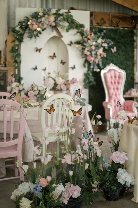 Butterfly-themed bridal shower setup with pastel chairs, pink flowers, and butterfly accents Rose Garden Bridal Shower Party Ideas, Fairy Themed Bridal Shower Ideas, He Gives Her Butterflies Bridal, Wedding Shower Butterfly Theme, Enchanted Garden Bridal Shower Theme, Bridal Shower Garden Party Theme, Pink And Green Bridal Shower, Secret Garden Bridal Shower Theme, Fairy Bridal Shower Ideas