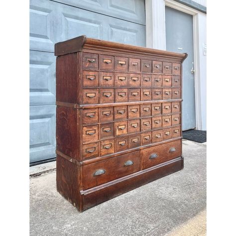 Antique Oak Apothecary Drawer Cabinet from the late 1800s.   An absolute unique drawer chest! An apothecary or florist drawer file from the mid-late 1800s. Each mini drawer interior has a full metal scoop design, see how each has a metal box covering the top with tapered sides. Originally used for seed (packet) storage, each drawer can set into an angle for accessing without removing the drawer. All drawers can be taken out with ease. All original hardware and drawer pulls. Each drawer pull has a brass plaque for use of labels, if desired.   This type of drawer design can be used in a studio or hospitality setting, for specific tool storage or even brought back to life in a working shop for merchandise or stock items.   This is a sectional cabinet, similar to barrister book case designs; f Metal Apothecary Cabinet, Vintage Card Catalog, Apothecary Dining Room, Apothecary Closet, Antique Apothecary Cabinet, Apothecary Organization, Apothecary Workshop, Vintage Study Desk, Antique Office Desk