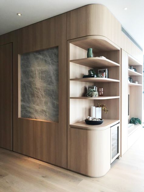 The dos and don’ts of custom joinery. Love this full wall bookshelf turned mini bar and entry feature wall. Statement custom joinery elevates this home. Bar And Bookshelf, Entry Joinery, Office Mini Bar, Entry Way Cabinet Ideas, Curved Millwork, Full Wall Cabinets, Curved Walls Interior, Curved Feature Wall, Feature Wood Wall