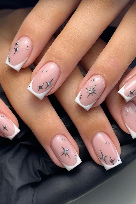 Channeling celestial beauty with French Tips adorned in delicate star constellations, this dreamy manicure combines a soft pink base with minimalist silver designs. The sparkling accents add a touch of enchantment to create a perfect, starry night-inspired look. // Photo Credit: Instagram @glamnails_bymeg Chrome Nail Ideas, January Nail, January Nail Designs, Star Nail Designs, Gel Nails French, Silver Nail Designs, White Tips, January Nails, Subtle Nails