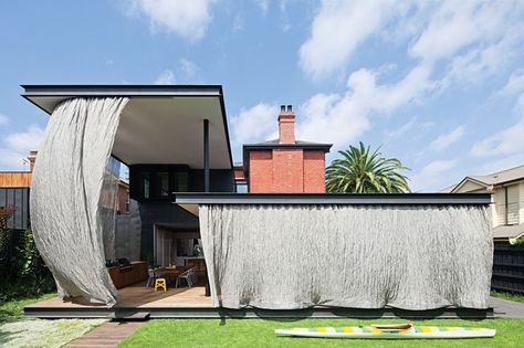 A unique design element brings this home by Matt Gibson Architecture   Design into the twenty-first century while preserving and celebrating the original Victorian home. Movement In Architecture, Mesh Curtain, Canvas Curtains, Steel Curtain, Front Yard Fence, Modern Fence, Up House, Backyard Fences, Japanese Architecture