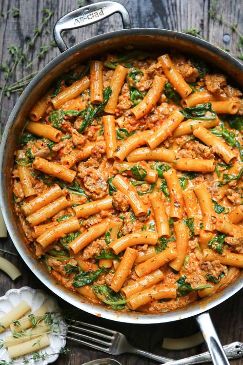 creamy sausage rigatoni with tomato sauce and spinach in a stainless steel skillet. Sausage Rigatoni Pasta, Creamy Sausage Rigatoni, Sausage Rigatoni Recipes, Rigatoni Recipe, Crockpot Chicken And Gravy, Sausage Rigatoni, Baked Pasta Dishes, Rigatoni Recipes, Stainless Steel Skillet