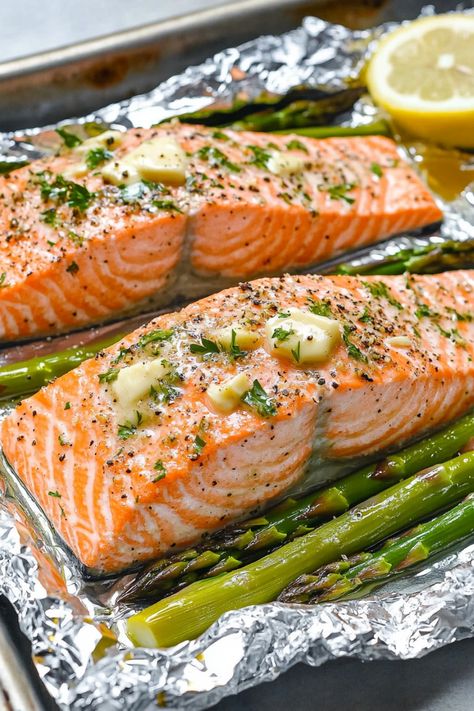 Discover the perfect weeknight dinner idea with this easy recipe for baked salmon and asparagus in foil. This dish is not only delicious but also quick to prepare, making it ideal for busy evenings when you want a healthy meal without all the fuss. The combination of tender salmon, flavorful asparagus, and zesty seasonings all cooked together in a foil packet creates a mouthwatering meal that will impress your family and friends. Salmon With Asparagus In Foil, Salmon Foil Packets Oven Asparagus, Oven Baked Salmon And Asparagus, Baked Salmon In Foil With Asparagus, Foil Packet Salmon Oven, Salmon Foil Packets Oven, Salmon And Asparagus In Foil, Fish In Foil Packets, Best Salmon Recipes