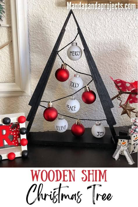 You’ll be Rockin’ around the Wooden Shim Christmas Tree this year after making this gorgeous black, red, and white themed DIY Christmas decor. This A-frame tree uses miniature Rae Dunn inspired ornaments for a sleek and classic look that’s a must add to your ‘Christmas crafts to make’ list this year! #diychristmasdecor Diy Wood Shim Christmas Trees, Wood Shim Trees, Wood Shim Christmas Trees, Trees Made From Shims, Shim Tree Ideas, Wooden Shim Christmas Tree, Christmas Tree Made Out Of Shims, Christmas Trees Made From Shims, Shims Projects Ideas