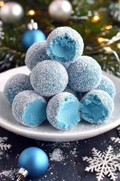 Blue Christmas Truffles start with a smooth white chocolate ganache, beautifully tinted by blue curacao, which adds a touch of warmth as they melt in your mouth. These truffles deliver a luscious blend of creamy white chocolate with a subtle citrusy note. Step into the world of holiday indulgence with these Blue Christmas Truffles—a dreamy Blue Christmas Truffles, Blue Pastries, Winter Wonderland Desserts, Winter Wonderland Treats, Candy Cane Truffles, Christmas Themed Food, Christmas Themed Desserts, Irish Cream Truffles, 21 Dinner