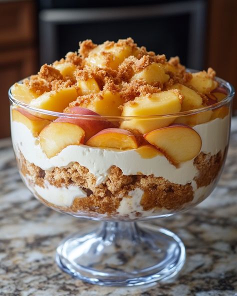 "This Peach Cobbler Trifle is a delightful dessert that brings together layers of peach goodness and creamy texture—perfect for summer gatherings!  For three decades, I've been perfecting this recipe, which my grandma used to make every summer. One spoonful, and you’re instantly transported to a warm afternoon. Link in first comment [👇] [👇]  Ingredients: - Fresh peaches - Vanilla pudding - Whipped cream  For the rest of the ingredients and detailed instructions, Link in first comment [👇] [👇]   Get ready to impress everyone with this deliciously layered dessert! 🍑✨   #PeachCobbler #Trifle #SummerDesserts #HomemadeGoodness #ComfortFood" Peach Cobbler Trifle, Honey Trifle, Parfaits Desserts, Peach Trifle, Spiced Whipped Cream, Fall Deserts, Layered Dessert, Parfait Desserts, Soul Food Dinner