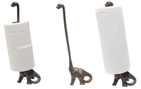 Iron Dinosaur Paper Towel Holder Wrangles Rolls Of Bounty Atop A Brontosaurus #decor #dinosaur #kitchen If we tried our very damnedest, we could not overstate our relief that dinosaurs are both no longer ruling the planet to witness humanity frequently r... Dinosaur Kitchen Utensils, Dinosaur Kitchen Decor, Dinasour Bathroom Ideas, Dinosaur Home Decor, Fun Bathroom Themes, Dinosaur Bathroom Decor, Dinosaur Bathroom Ideas, Dino Bathroom, Dinosaur Kitchen