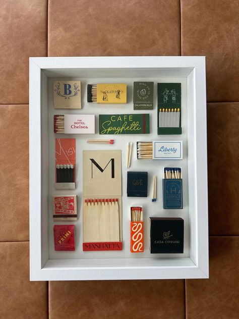 Custom Matchbook Shadowbox White Shadowbox  -American Flat Frame -12 inches wide -15 inches tall -2.5 inches thick Featuring a mix of vintage matchbooks and trendy restaurants! -Nick & Toni's  -Calicoon Hills -The Hotel Chelsea -Cafe Spaghetti -Misi -Manhatta -Liberty Bistro -Bar Primi -Bad Roman -Harry's Wall Street -Casa Cipriani -Gage & Tollner -Vintage Matchbook - The Chatter Box New Lexington Vintage Diy Gifts, Match Frame, Matchbox Display, Matchbook Collection Display Ideas, Souvenir Box Ideas, Diy Matchbook Art, Match Book Collection Display, Match Book Art, Display Matchbooks