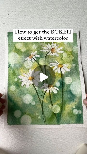 Watercolor Arist | Bree Copley on Instagram: "Love the feel the bokeh effect gives these watercolor daisies ! This technique is really simple and easy to achieve if you have the right tools. be sure to SAVE  for later and SHARE with all your watercolor friends!   Here are the supplies you will need to help you achieve this Bokeh effect.  -masking fluid  -circle stencil  -magic eraser ( the kind you use for cleaning) You can also use a natural sea sponge.  -paper towels  HELPFUL TIPS - you can use any color for the background , so choose more than one.  - when using multiple  colors try not to manipulate the colors or blend them together too much. You don’t want the paint to end up muddy  - be gently with the sponge , rubbing too hard can ruin your paper  -you can also add color washes to y Bokeh Effect Watercolor, Watercolour Masking Fluid, Watercolor Bokeh Tutorial, Watercolor Videos Tutorial, Watercolor Background Tutorial, Watercolor Friends, Masking Fluid Watercolor, Nature Watercolor Paintings, Bokeh Watercolor