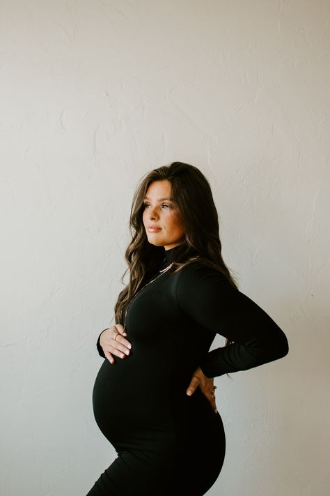 Winter Maternity Pictures Dress, Black Dress Maternity Dress, Maternity Pics Black Dress, Mommy Me Maternity, Maternity Photo Dress Fall, Tight Pregnancy Dress, Indoor Maternity Photoshoot Outfits, Long Sleeve Maternity Dress Photo Shoot, Black Sweater Dress Maternity Photos