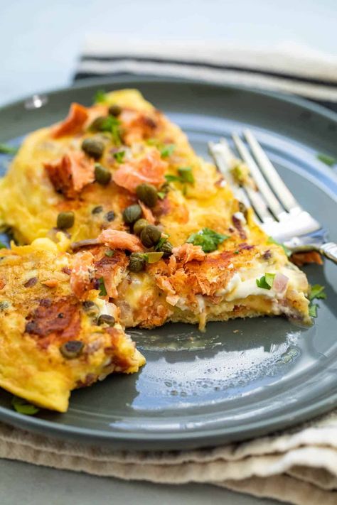 Here is a delicious smoked salmon omelette recipe that makes a quick and tasty breakfast. My version includes capers, red onion, and cream cheese! macheesmo.com #omelette #smokedsalmon Smoked Salmon Omelette Cream Cheeses, Eggs Smoked Salmon Breakfast, Salmon Omelette Recipe, Salmon Omelette Breakfast, Salmon Eggs Breakfast, Omelettes Recipe, Wednesday Meals, Keto Omelette, Salmon Omelette