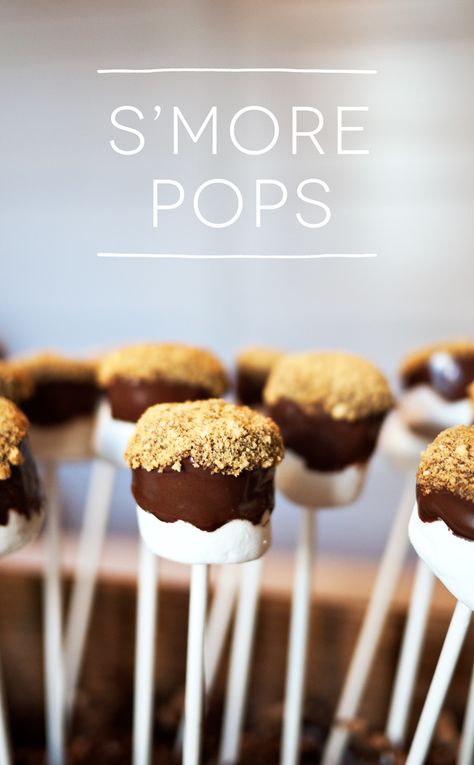 Marshmallow S'more Pops! Going to a holiday party, or hosting one of your own? You need these sweet treats in your life! It's an easy dessert with only 3 ingredients S’more Marshmallow Pops, Hedgehog Donut Holes Recipe, Smore Marshmallow Pops, S’more Pops, Big Marshmallows Ideas, Marshmallow Ideas For Party, Smores Marshmallow Pops, Diy Party Desserts Treats, Marshmallow Smores On A Stick