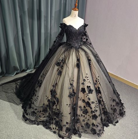 Timeless vintage-inspired Black Sweetheart Quinceanera Dress. Featuring an intricate beadwork bodice, off-the-shoulder long sleeves with a dramatic floral drape shoulder cape, this dress exudes glamour and luxury. The black lace overlay complete with hand sewn florals adds a touch of elegance, while the adjustable lace-up back ensures a perfect fit. Elevate your party look with this exquisite ball gown. material: glitter tulle, organza type: ball gown style: formals color as shown built in bra s Bell Sleeve Ball Gown, Medieval Queen Dresses, Victorian Ball Gowns Black, Black Puffy Wedding Dress, Black And White Ball Gowns, Ethereal Black Wedding Dress, Plus Size Dark Wedding Dress, Dark Wedding Dress Black Laces, Black Wedding Dresses Black Women