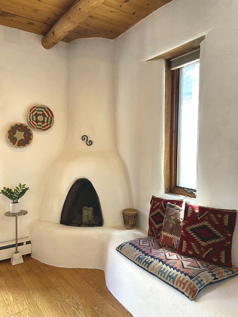 Chattadoe House - A dreamy vacation home in Taos, New Mexico. Kiva fireplace, kilim pillows, adobe, vigas ceilings Adobe Homes New Mexico, New Mexico Adobe Homes, New Mexico Home Interior, Beehive Fireplace, New Mexico Style Home, New Mexico Decor, Adobe Fireplace, Southwest Living Room, Dreamy Vacation