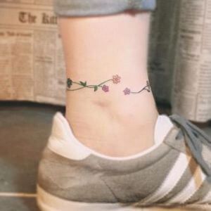 Flower Chain Tattoo, Daisy Chain Tattoo Ankle, Daisy Chain Tattoo, Chain Tattoo, Ankle Tattoo Designs, Daisy Tattoo, Wolf Tattoo Design, Wolf Tattoo, Ankle Tattoo