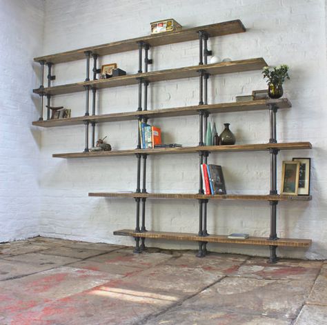 Or use repurposed scaffolding. | 27 Insanely Clever Ways To Display Your Books Galvanized Pipe Shelves, Steel Pipe Shelving, Pipe Bookshelf, Wide Bookcase, Creative Bookshelves, Industrial Bookcases, Wall Mounted Bookshelves, Vintage Industrial Design, Diy Pipe