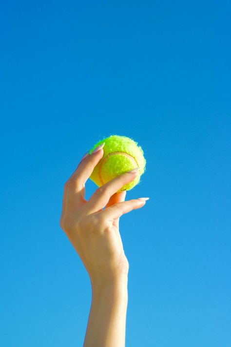 Close-up of a Person Holding a Tennis Ball on the Background of Blue Sky · Free Stock Photo Tennis Moodboard, Blue Sky Background, Photo Equipment, Sky Background, Hand Holding, Tennis Ball, Reference Photos, Close Up Photos, Vibrant Blue