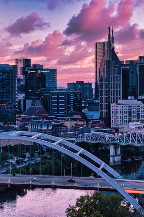 Skyline of Nashville shot from across the river as the sun sets and the sky in pink and full of clouds. Nashville Tennessee Aesthetic, Nashville Aesthetic, Tennessee Aesthetic, Nashville City, Music City Nashville, Nashville Music, Thanksgiving 2024, Luxury Collection Hotels, Driver Era