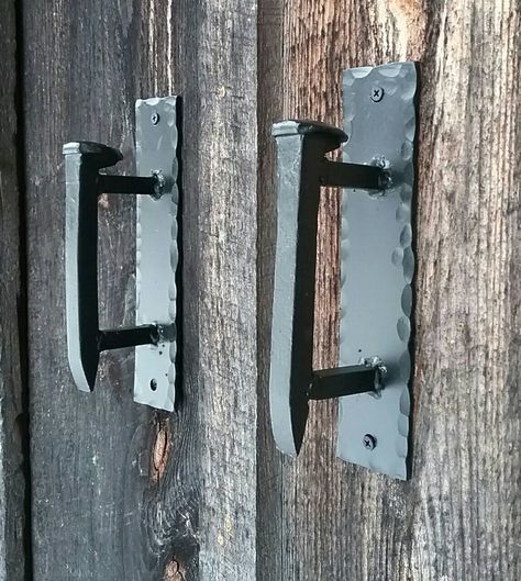 These sturdy door pulls were made by hand in the forge on our Pennsylvania farm. Listing is for a set of 2. They measure approximately 8.75" high x 2" wide. The handles are made of authentic railroad spikes and will come away from the wall about 3" and are 6.5" long. Please note sizes are approximate and will vary slightly as each piece is a handmade original. Feel free to contact us about a custom order if you need them to be an exact size. The back plate has hand hammered texturing around the Railroad Spikes Crafts, Railroad Spike Art, Cool Welding Projects, Welded Metal Projects, Welding Crafts, Railroad Spikes, Blacksmith Projects, Casa Country, Welding And Fabrication