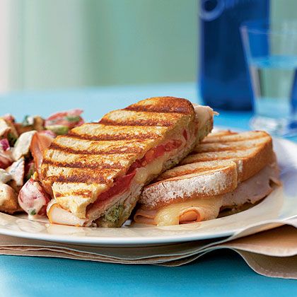 This turkey panini is one of the best panini recipes we have ever tried. Basil pesto and sourdough bread are key to this sandwich's... Best Panini Recipes, 300 Calorie Dinner, Hearty Sandwiches, Turkey Panini, Noom Recipes, Cheese Panini, Quick Sandwiches, Cooking Light Magazine, Panini Recipes