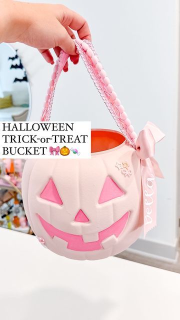 Shelby Parks on Instagram: "Wait until you see how cute he is !!  Halloween buckets can either be SO ugly or so expensive!   So I decided to give the cheap plastic Jack-o-Lantern a ✨glow up✨ by swapping out the handles and using some random things I had around the house   Of course I made mine pink but you could easily recreate this with a different color scheme (I mean how cool would black be???)  *Comment ZHUZH to get all of the tools and supplies I used sent to your inbox 💌  #halloween #halloweendiy #diyhalloween #pinkhalloween #diy #transformation #spookyseason #halloweendiys #howto" Halloween Pumpkin Bucket Ideas, Pumpkin Trick Or Treat Bucket, Diy Halloween Bucket, Pumpkin Bucket Diy, Diy Halloween Buckets For Kids, Diy Trick Or Treat Buckets, Painted Halloween Buckets, Halloween Buckets Ideas, Diy Halloween Buckets