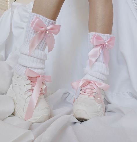 white leg warmers with pink bows. Each bow has a danggling chain with pearl and pink crystal heart beads. Model is wearing these leg warmers with chunky white platforms with pink ribbions as the shoe laces. There is a bunny charm with angel wings and heart charm on one shoe and a pink translucent my melody charm and a cat paw charm on the other shoe. Kawaii, Bow Leg Warmers, Soft Core Clothes, Soft Pink Clothes, Shoes With Leg Warmers, Pastel Pink Clothes, Leg Warmers Shoes, Kawaii Clothes Pastel, Leg Warmers Aesthetic