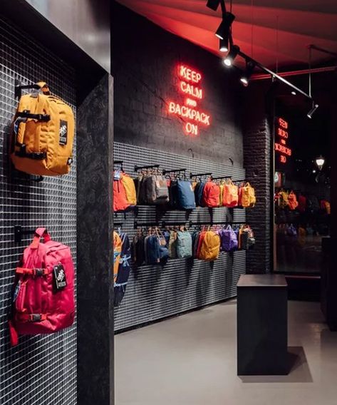 Grid Wall Clothing Display, Bag Display Ideas Retail, Backpack Store, Clothing Store Interior, Urban Backpack, Clothing Store Design, Spain Design, Metal Grid, Grey Brick