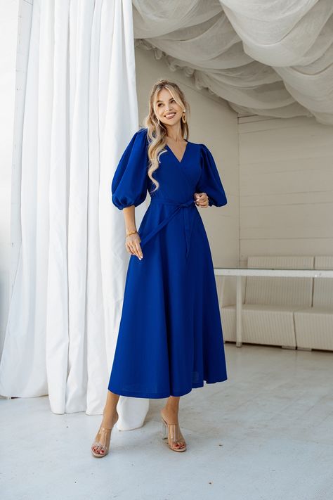 Step into a world of vibrant elegance with our Blue Puff-Sleeve Wrap Midi Dress. The striking blue color commands attention, while the puff sleeves add a touch of drama and romance. The wrap design not only flatters your figure but also allows for easy adjustability. #mididress #wrapdress #dress #dresses #dresslover #womenwear #summerdress #springdress #weddingdress #eveningdress #bluedress Professional Fits, Slavic Style, Backless Midi Dress, Midi Dress Blue, Top Girl, Evening Dresses With Sleeves, Blue Dress Formal, Elegant Dresses Classy, Wear Store