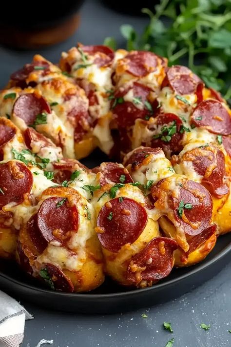 Pizza Monkey Bread combines gooey cheese, pepperoni, and seasoned dough into a pull-apart dish that’s perfect for parties, game nights, or family dinners. This easy recipe bakes in just 35 minutes and is served with marinara sauce for dipping. Everyone will love pulling apart this cheesy, savory bread! Try it today and share your creations! Monkey Pizza Bread, Pepperoni Monkey Bread, Monkey Pizza, Pizza Monkey Bread, Pull Apart Pizza, Pull Apart Pizza Bread, Canned Biscuits, Pizza Flavors, Monkey Bread