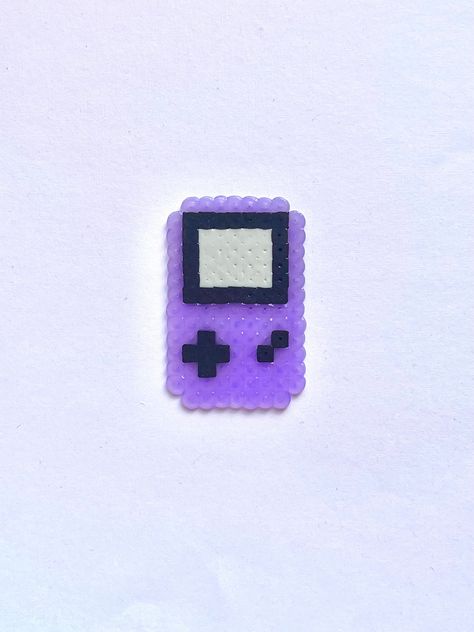 A Blast From the Past! Return to simpler times with a mini Gameboy to keep in your pocket. Our handmade gameboy constructed from Perler Beads is light weight and fun to keep as a reminder of your favorite nostalgic game. Things To Make Out Of Iron Beads, Perler Bead Beach Patterns, Small Perler Bead Designs, Perler Bead Patterns Small Easy Pokemon, Small Perler Patterns, Small Perler Bead Patterns Minis, Mini Perler Beads Ideas, Tiny Perler Bead Patterns, Hama Beads Aesthetic