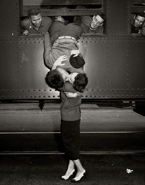 A soldier leans out of train window to kiss a woman goodbye in 1950. Black, A Train, Two People, Kiss, Train, Black And White, White