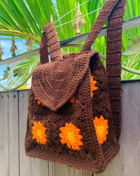 Wild Dandi on Instagram: “Hey Loves! I am loving this brown-orange-gold take on the dandelion crochet backpack!! Swipe to see how you can incorporate this backpack…” Crochet School Backpack, Crochet Bagpack Aesthetic, Crochet Granny Square Backpack Free Pattern, 70s Crochet Bag, Granny Square Backpack Free Pattern, Cool Crochet Bags, Brown Crochet Projects, Orange Yarn Crochet Projects, Brown Yarn Crochet Ideas