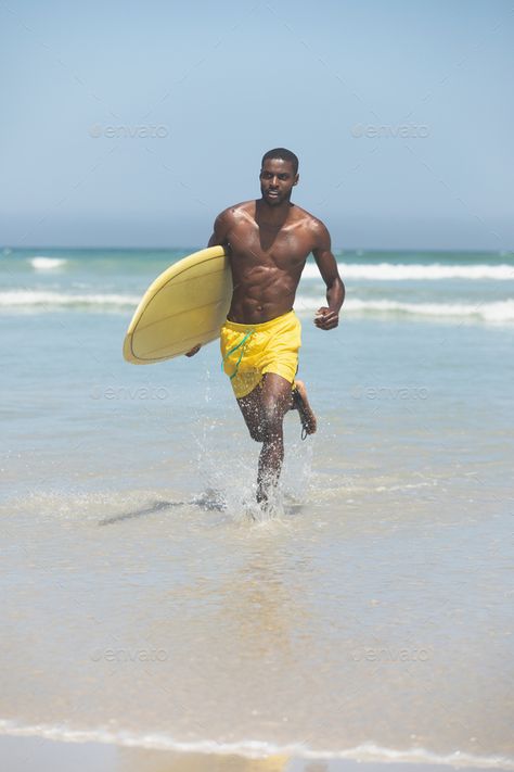 Fit male surfer with a surfboard running out of the water on a beach by Wavebreakmedia. Front view of handsome fit African American male surfer with a surfboard running out of the water on a beach on sunny... #Affiliate #running, #water, #beach, #surfboard Male Surfer, Beach Surfboard, Running Water, Mellow Yellow, Front View, Surfboard, African American, Beautiful Homes, Surfing