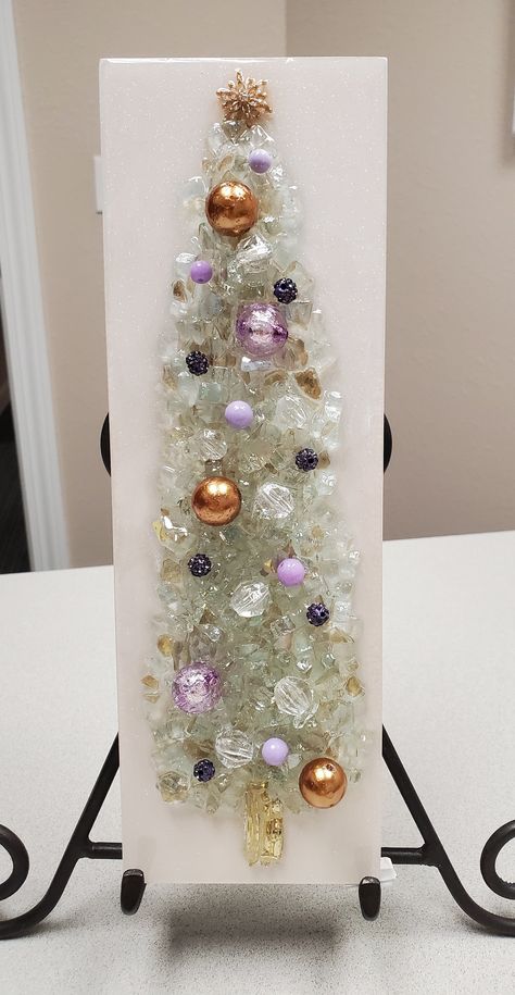 This unique, beautiful decorative Christmas tree, displayed on either your wall or shelf, will be a huge attention grabber this holiday season!  It's are made of crushed glass, beads and other embellishments, and the epoxy resin finish gives them a dazzling shine.  This piece measures 12" high by 4" wide.  This piece has LED lights and comes with an extra set of batteries. PLEASE HANDLE OUR GLASS ART CAREFULLY! TERRI'S GLASSY CREATIONS IS NOT RESPONSIBLE FOR INJURY CAUSED BY MISHANDLING OF OUR GLASS ART. Wall Decor Shelf, Broken Glass Crafts, Fall Pumpkin Centerpieces, Resin Christmas, Glass Art Pictures, Jewelry Christmas Tree, Christmas Tree Art, Glass Art Projects, Decor Shelf