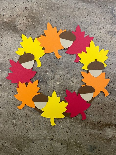 "This adorable fall wreath will make a great fall decoration for your home. Let your child arrange the wreath in whichever way they like best! :) I will send you all the pieces you need cut out of colored cardstock...all you need is glue! :)  You may want to add some tape to the back of the wreath for extra support! :) Fall wreath measures about 7.5\" across What's included: *2 brown half circles *3 red leaves *3 orange leaves *3 yellow leaves *5 dark brown acorn tops *5 light brown acorn bottom Fall Wreath Craft, Thanksgiving Crafts Elementary, Cardstock Paper Crafts, Couronne Diy, Paper Craft For Kids, Fall Classroom Decorations, November Crafts, Fall Leaf Wreaths, Kids Fall Crafts