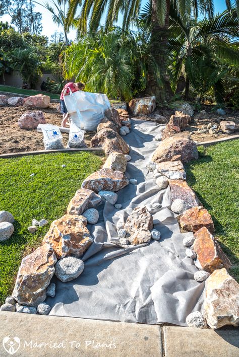 The building of a dry creek bed Dry Creek Bed For Drainage Rain Garden, Rockery Around Pool, Boulder Landscaping Ideas Natural Stones, Dry Creek Bed With Pond, River Rock Sitting Area, Dry Riverbed Landscaping Slope, Dry Pond Landscaping, Rock Landscaping Ideas Front Yard Drought Tolerant Dry Creek Bed, Dry Creek Bed For Drainage Slope