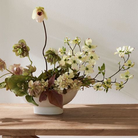 Designed for low lush arrangements, the ceramic compote is a quintessential centerpiece vessel. Slip cast by hand for a seamless finish, its oval ceramic body inspires a natural and organic style of arrangement. When not containing flowers it can also be used as a catch-all, a fruit bowl or as a sculptural object. It's a stunner! size: 5.5" wide, 8" long, 4" tall sold individually available in two colors food, microwave, dishwasher and oven safe hand finished—slight variations may occur Wide Flower Arrangements, Organic Floral Centerpieces, Ceramic Bowl Flowers, Low Floral Arrangements For Table, Wedding Ceremony Arrangements, Pedestal Bowl Flower Arrangement, Low Bowl Floral Arrangement, Low Vase Floral Arrangements, Neutral Flower Arrangements