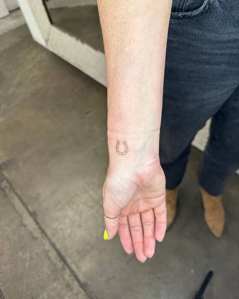 Minimalistic style horseshoe tattoo done on the wrist. Horseshoe Wrist Tattoo, Small Horshoe Tattoo, Horseshoe Hand Tattoo, Small Horse Shoe Tattoos, Fine Line Horseshoe Tattoo, Tiny Horseshoe Tattoo, Dainty Horseshoe Tattoo, Small Horseshoe Tattoo, Good Luck Tattoos