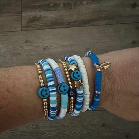 Homemade Stackable Bracelets. Smiley Face Friendship With Evil Eye And Shell. Blue And White Themed 2 Accent Gold Beaded Brackets As Well Set Of 7 - Can Stack In Any Order Or Rotate So Brad Isn’t Showing ** Custom Order Upon Request Check Out Other Listings For Bulk Shipping Trendy Summer Bracelets 2023, Blue Bracelet Ideas Clay Beads, Summer Bracelets Pura Vida, Clay Beads Friendship Bracelet Ideas, Elegant Clay Bead Bracelets, Abba Jewellery, Bracelet Patterns Flat Beads, Flat Bracelet Ideas, Blue And White Clay Bead Bracelets