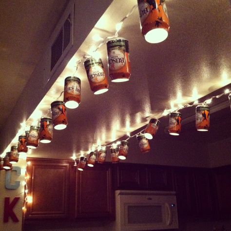 I've got a whole bunch of retro miller lite cans...this is happening! Beer Can Lights Diy, Beer Can Lights, Beer Can Decorations Diy, Beer Can Christmas Decorations, Beer Can Chandelier, Diy Beer Can Crafts, Beer Can String Lights, Beer Can Decor, Beer Can Art Diy