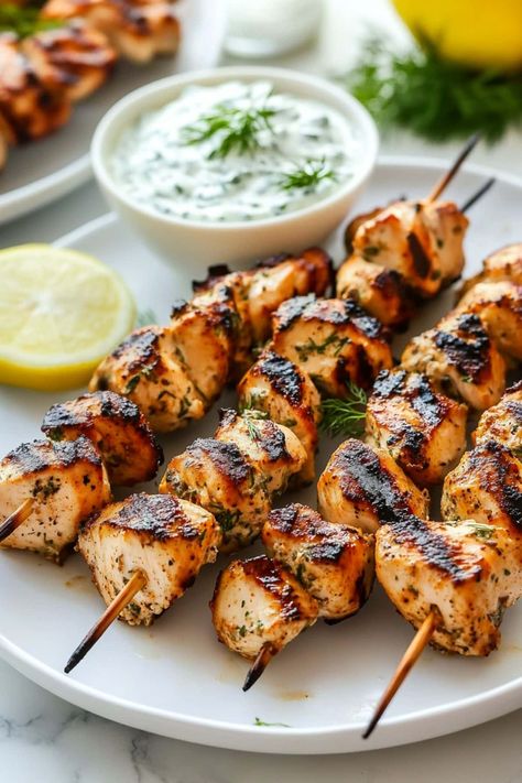 Greek chicken souvlaki with tzatziki brings the vibrant flavors of the Mediterranean right to your table. It's savory, zesty, and oh-so-juicy. Greek Wraps Chicken Tzatziki Sauce, Greek Dishes Traditional Chicken, Greek Family Dinner, Grilled Chicken Souvlaki, Greek Chicken Spices, Greek Dishes Appetizers, Chicken Euros Recipe, Chicken And Tzatziki Recipes, Greek Chicken Dishes