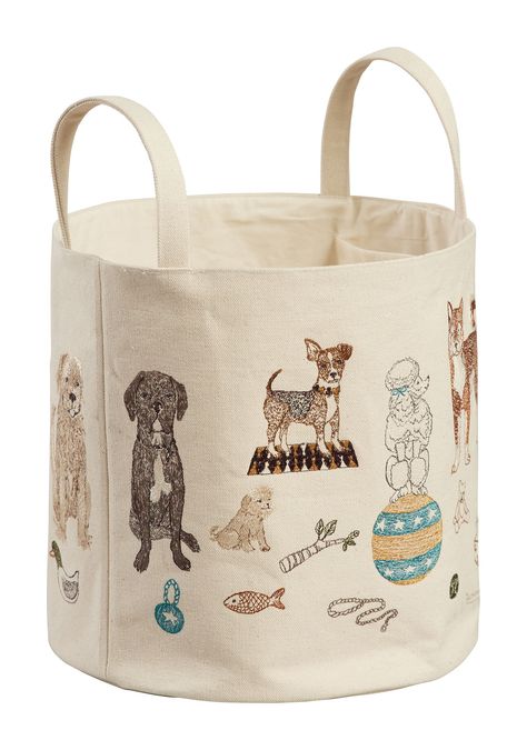 Elevate your pet toy storage with a cute canvas bucket! Constructed from sturdy cotton canvas, our Dog Toy bucket features playful pups posing with their prized toys on all sides. Unleash the possibilities of attractive organization with our fabric buckets! Measures 11" × 11". Handle drop measures 4". New Pet Gift Basket, Get Well Gift Basket Dog, New Puppy Gift Baskets, Dog Stuff Aesthetic, Dog Supply Storage, Dog Supplies Storage, Dog Toy Organization, Philadelphia Apartment, Pet Toy Storage