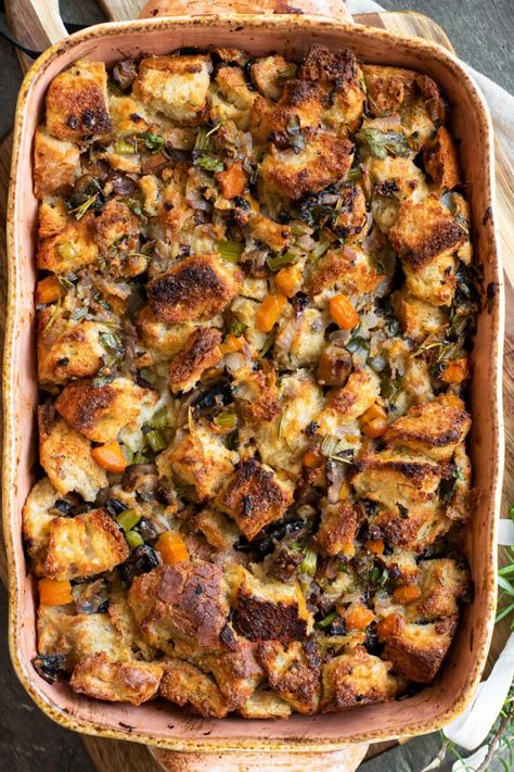 This simple vegetarian stuffing recipe should be a staple at every Thanksgiving and Christmas celebration! It’s savory, flavorful, and delicious with no need to bake bread ahead of time. https://www.savoringthegood.com/vegetable-stuffing-recipe/ Half Baked Harvest Thanksgiving Stuffing, Vegetarian Bread Stuffing, Root Vegetable Stuffing, Veggie Stuffing Recipes, Herbed Stuffing Recipes, Worlds Best Stuffing, No Meat Stuffing, Vegetarian Dressing Stuffing, Meatless Stuffing Thanksgiving